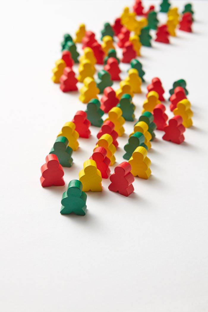 The Art of Drawing Readers In: Your attractive post title goes here An arrangement of colorful wooden game pieces in rows on a white background.